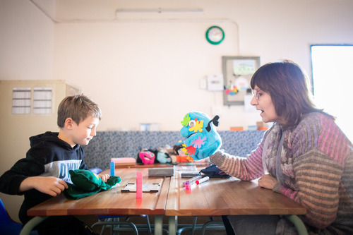 Photo of Petro engaging with a child using her innovation.