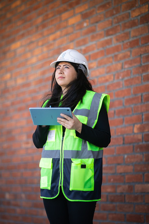 Photo of Vesile in a high-visibility coat, and a hard-hat.