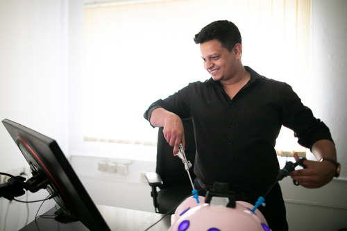 Photo of Saurya looking at a screen, and practicing with his technology.