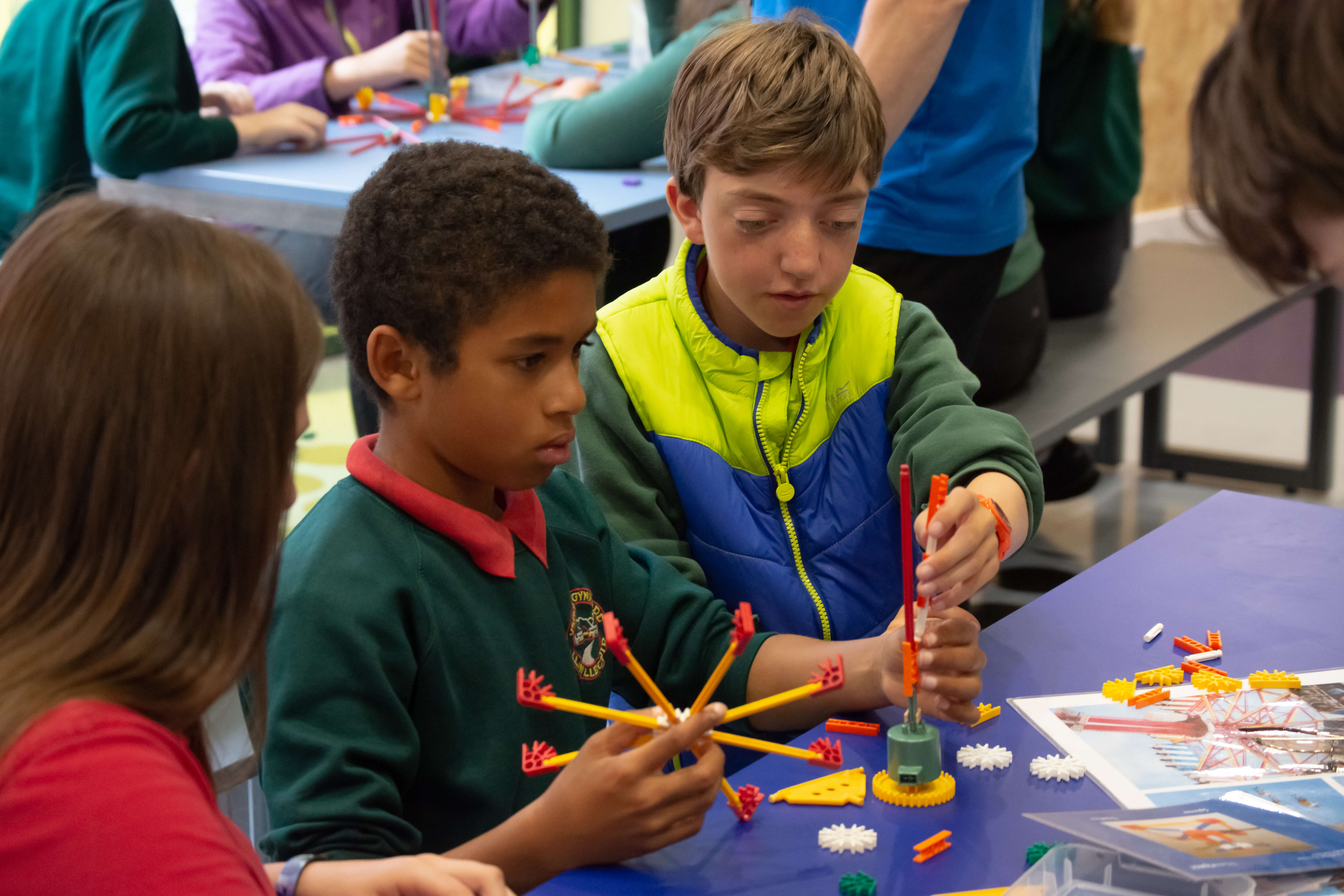 Picture showing 2 young students building a toy fairground ride