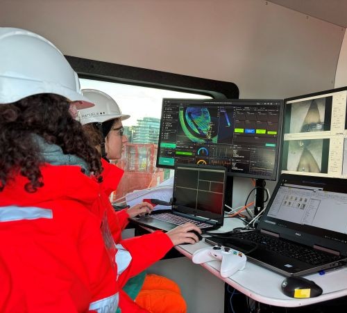Operators driving the robot and capturing live data from control van