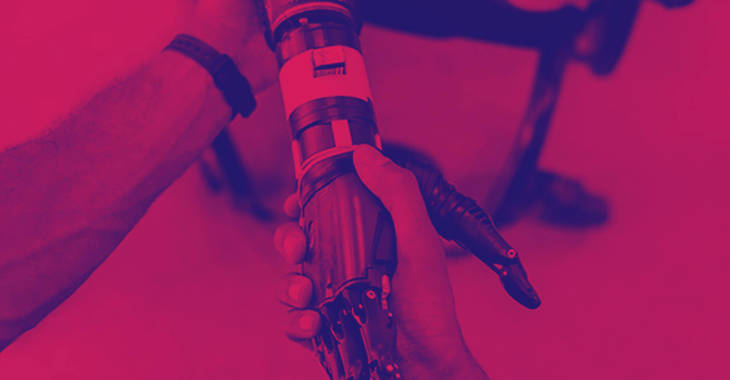 Mechanical engineer's arm holding a prosthetic arm.