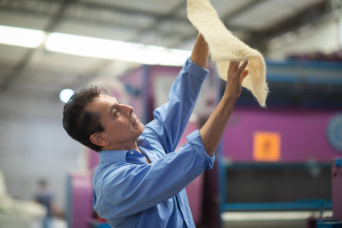 Photo of Alex holding the Fiquetex material in the air.