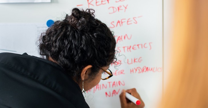 woman writing on whiteboard
