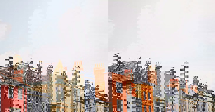 A row of houses with sky in the background