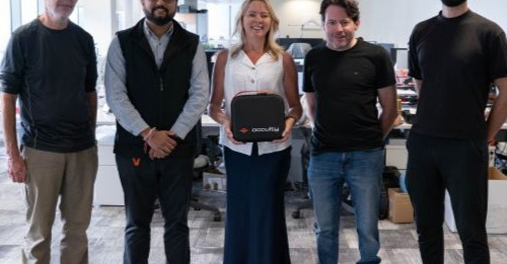 The Occuity team standing in their office.