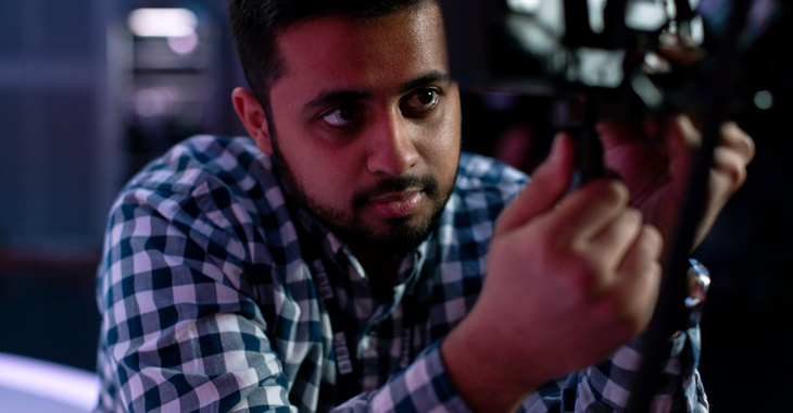 Male broadcast engineer works in studio