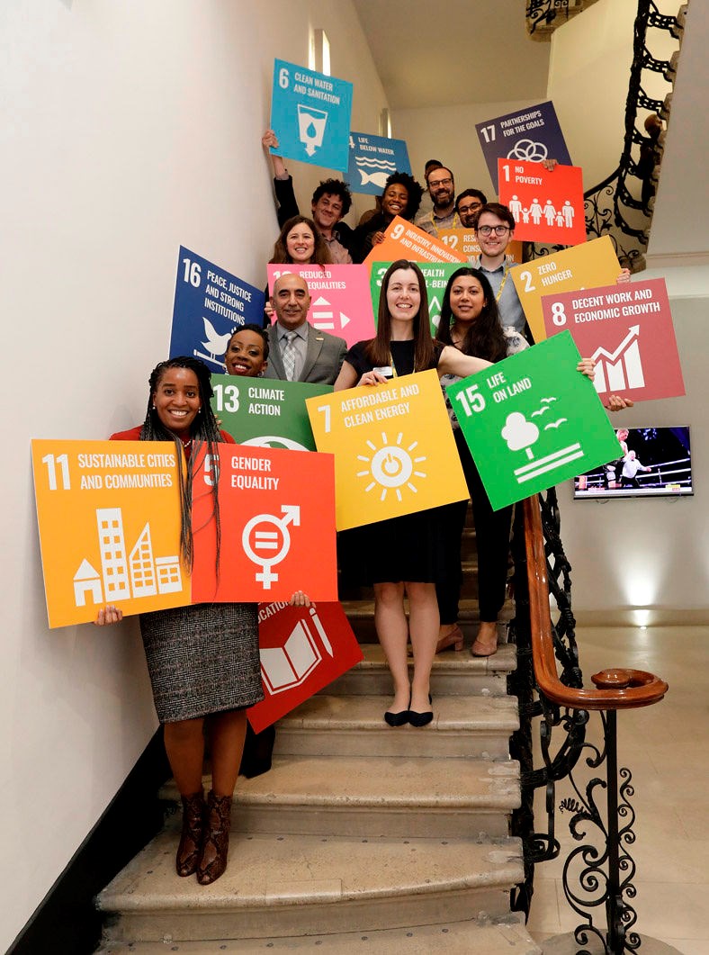 academy staff posing with SDG sign sin Prince Philip House