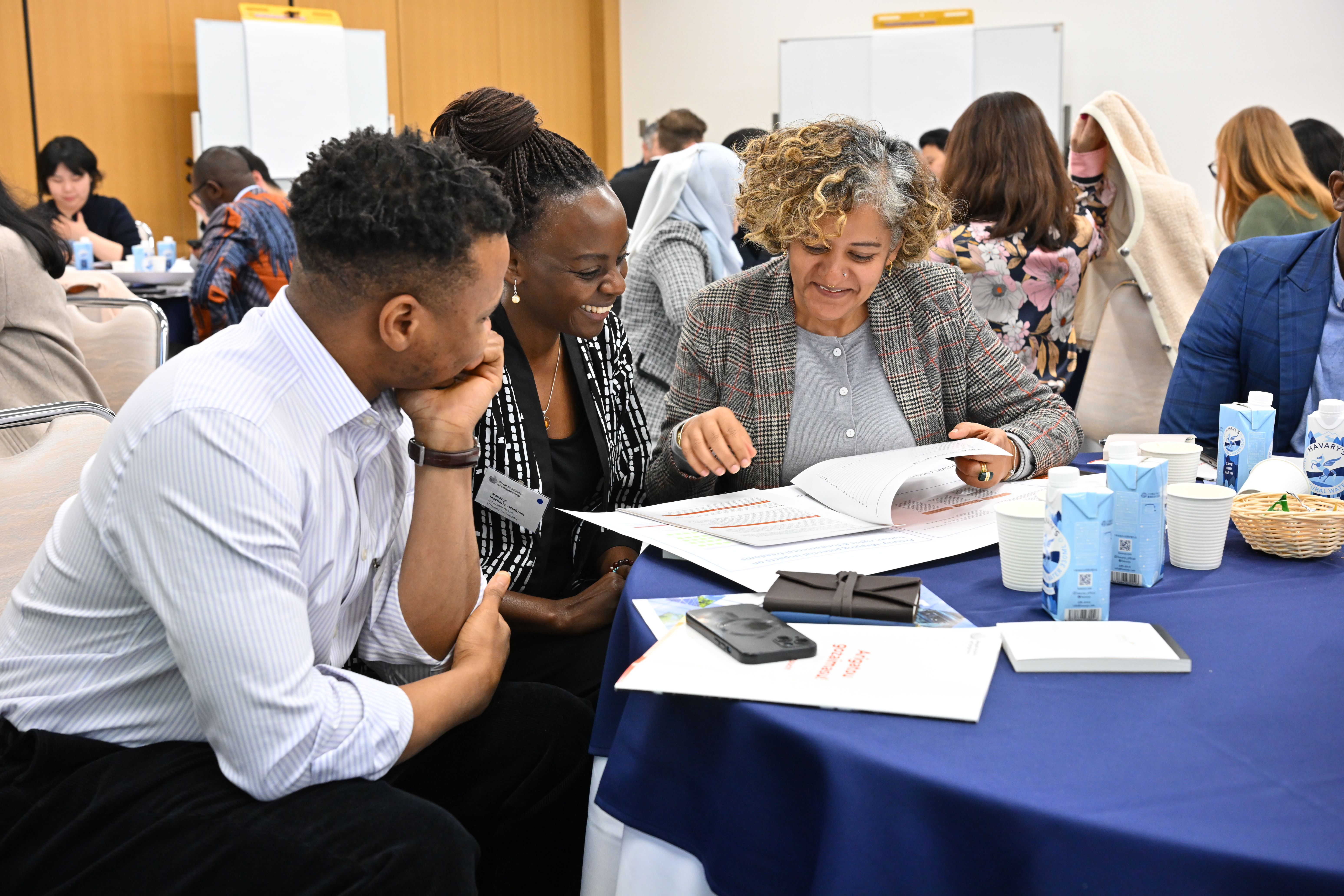 Three participants discussing during the first session activity.