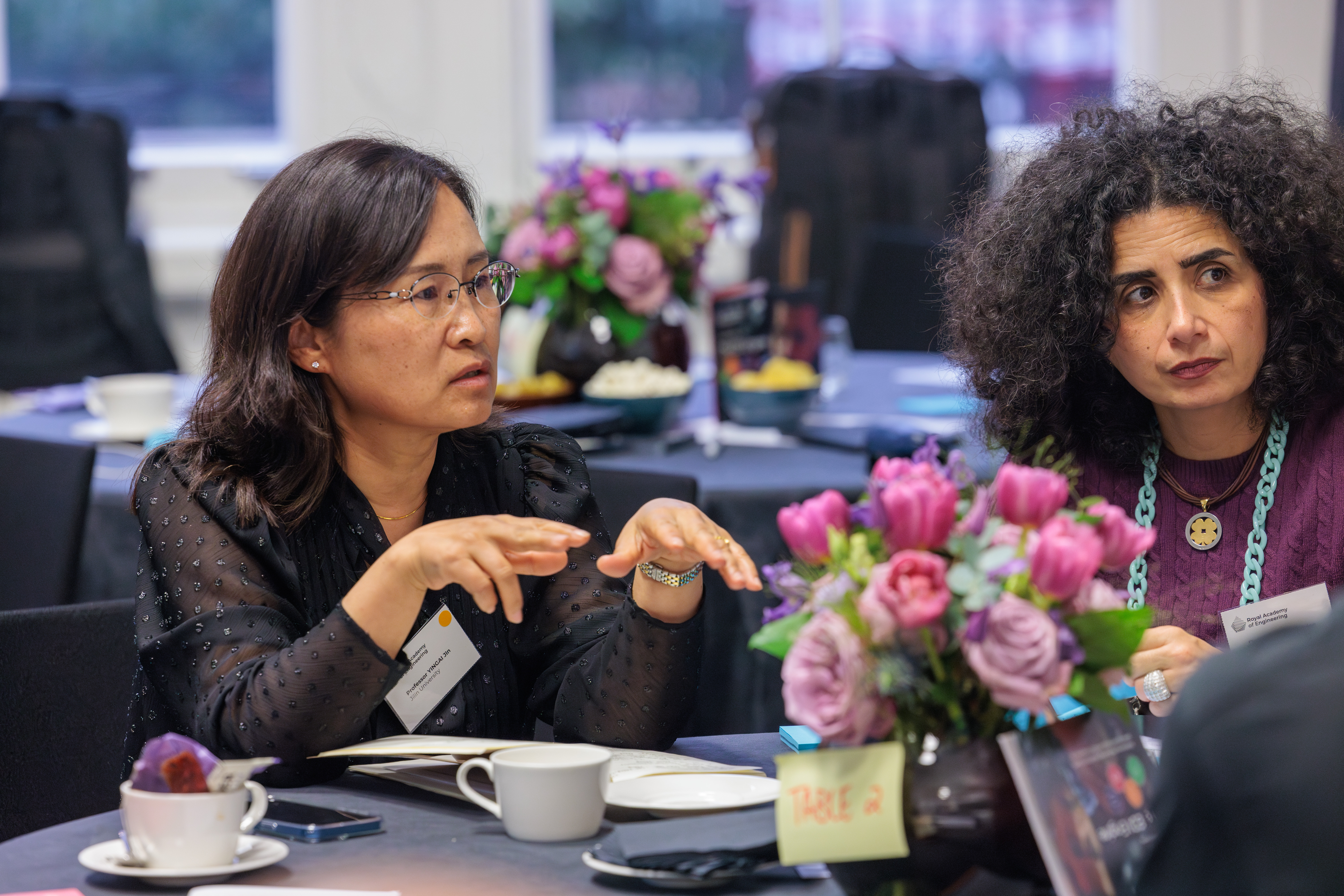 Two women sitting at a table talking