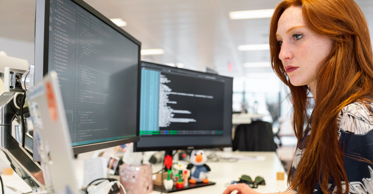 Female Software Engineer Codes At Computer Desk