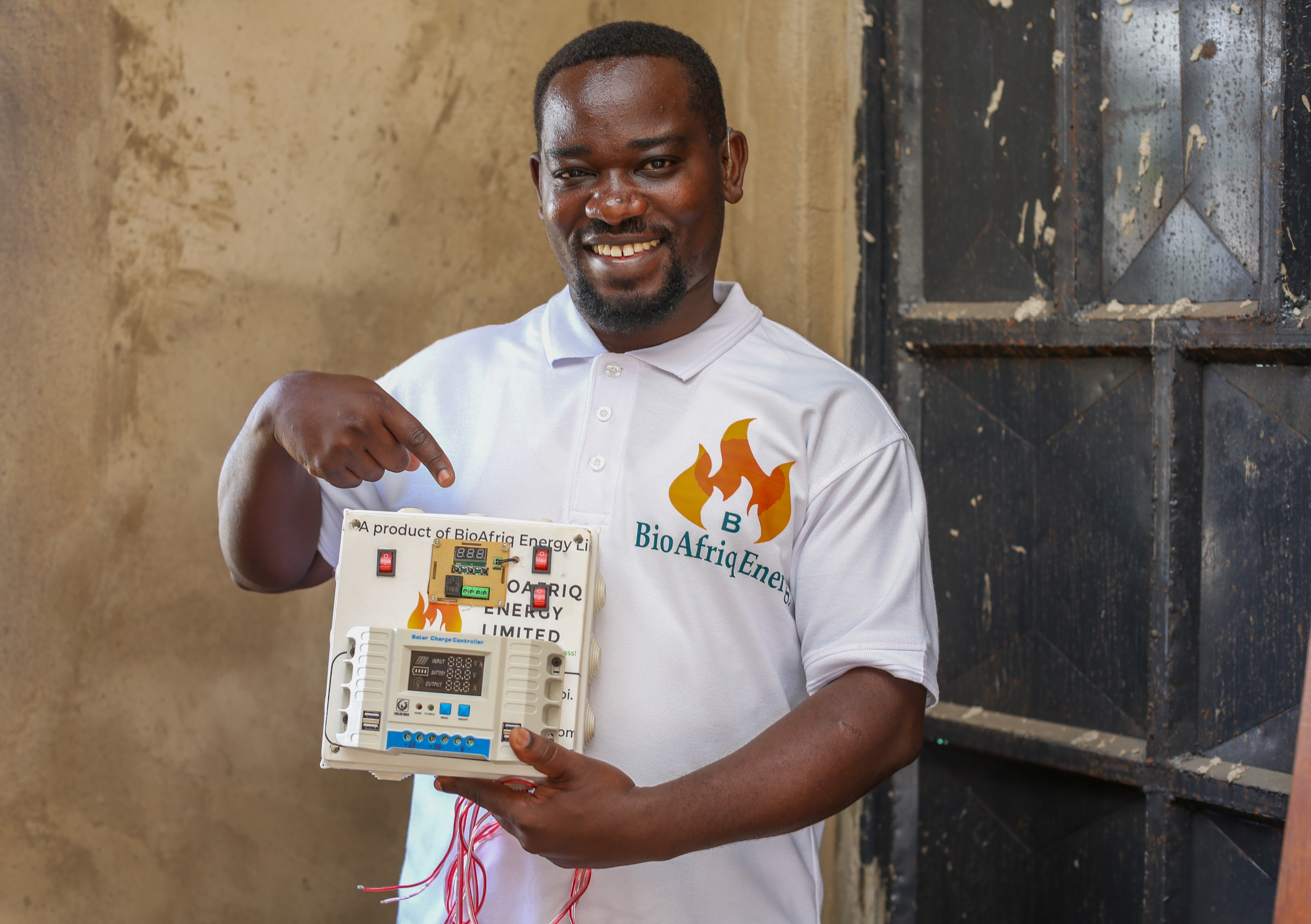 James Nyamai, holding the BioAfriq Energy Hybrid Solar Dryer.