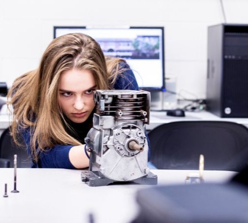 A Woman Works On Some Machinery