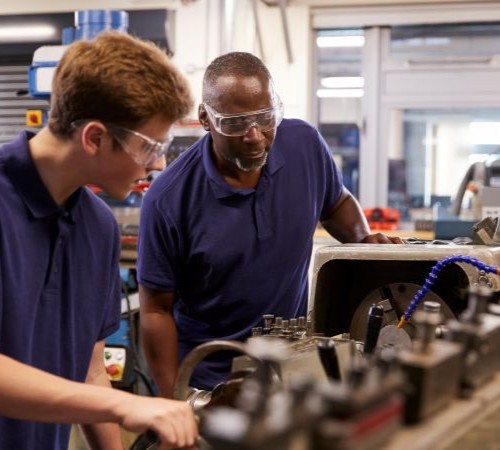 Two engineers Working On Machinery