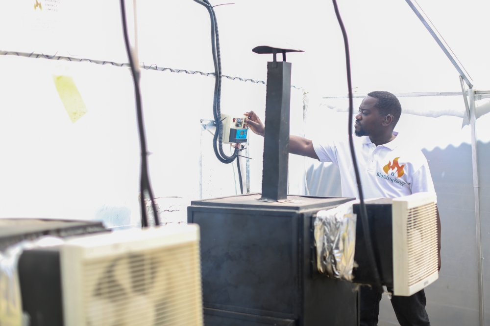 James Nyamai, operating the BioAfriq Energy Hybrid Solar Dryer.